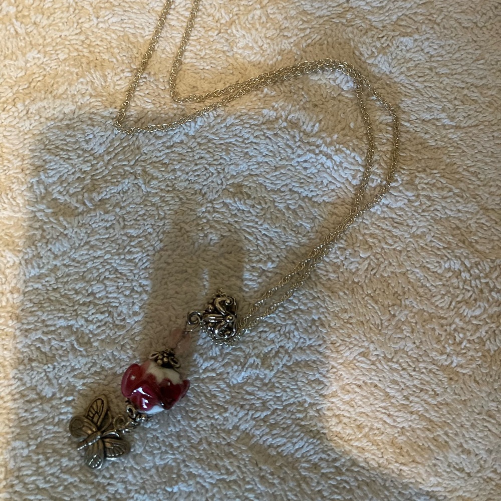 Sterling Silver with Heart Ceramic Rose and Butterfly. Chain is 20”